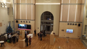 Interior view of the main atrium at the University of Greenwich Dreadnought Building, showing the large open student space.