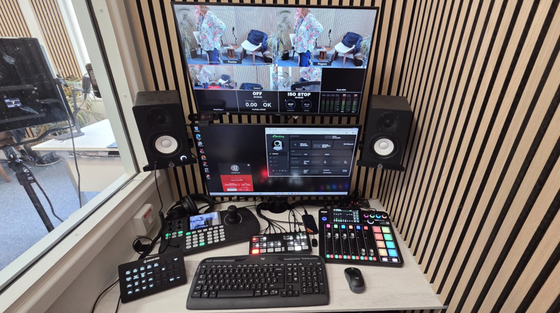 University of Greenwich podcast studio control room with video production equipment, audio mixer, control desk and monitors.